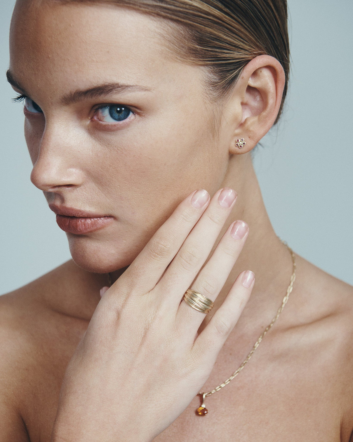 Astra Spessartite and Diamond Pendant, Arc Ring and Daisy Ruby Earrings in solid gold, worn