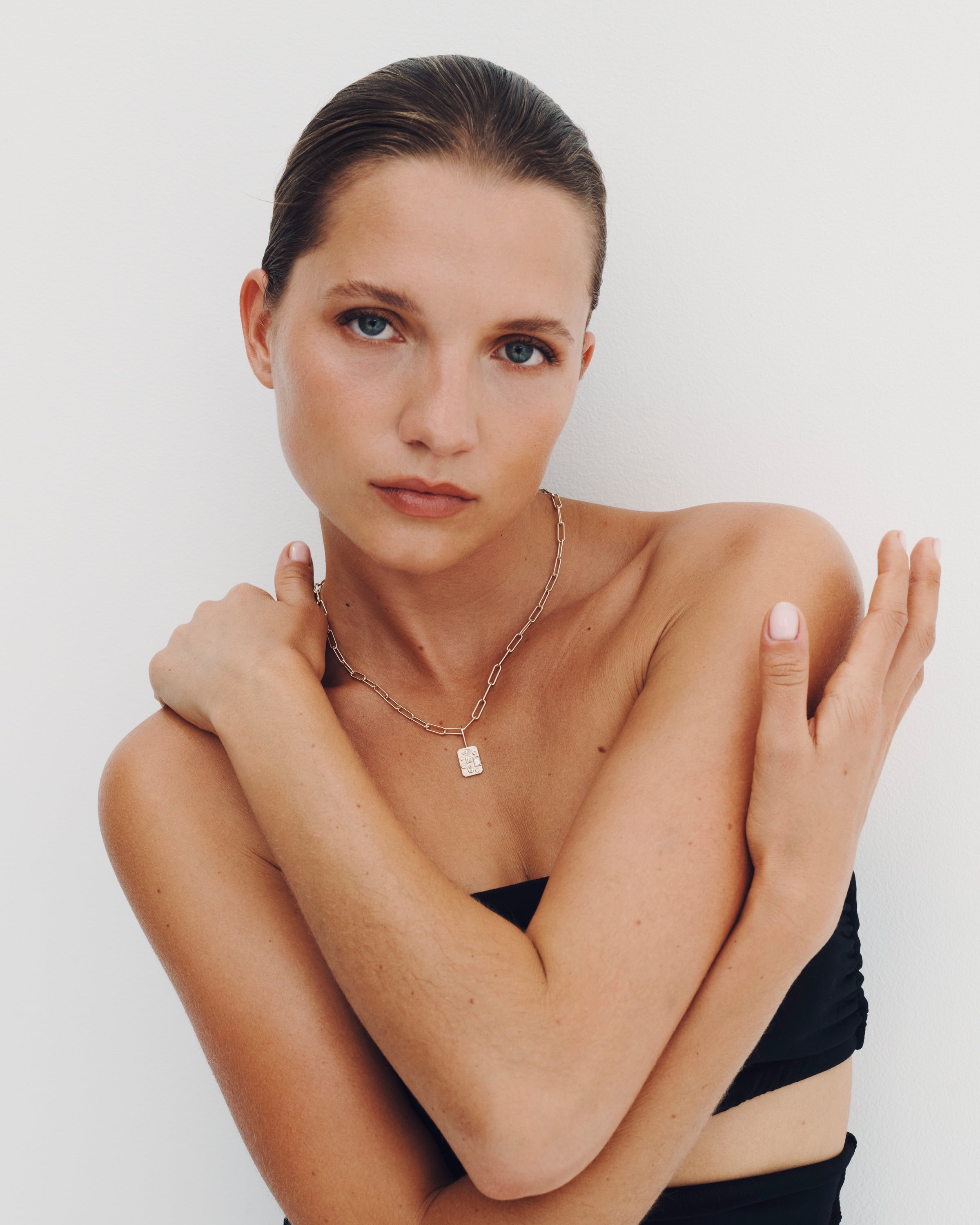 Woman wearing a necklace with a white background