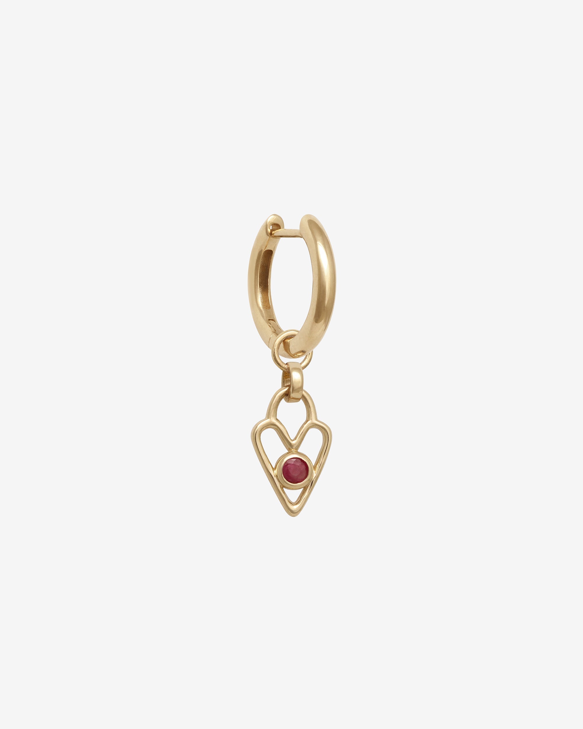 Gold hoop earring with a heart-shaped pendant and red gemstone on a white background