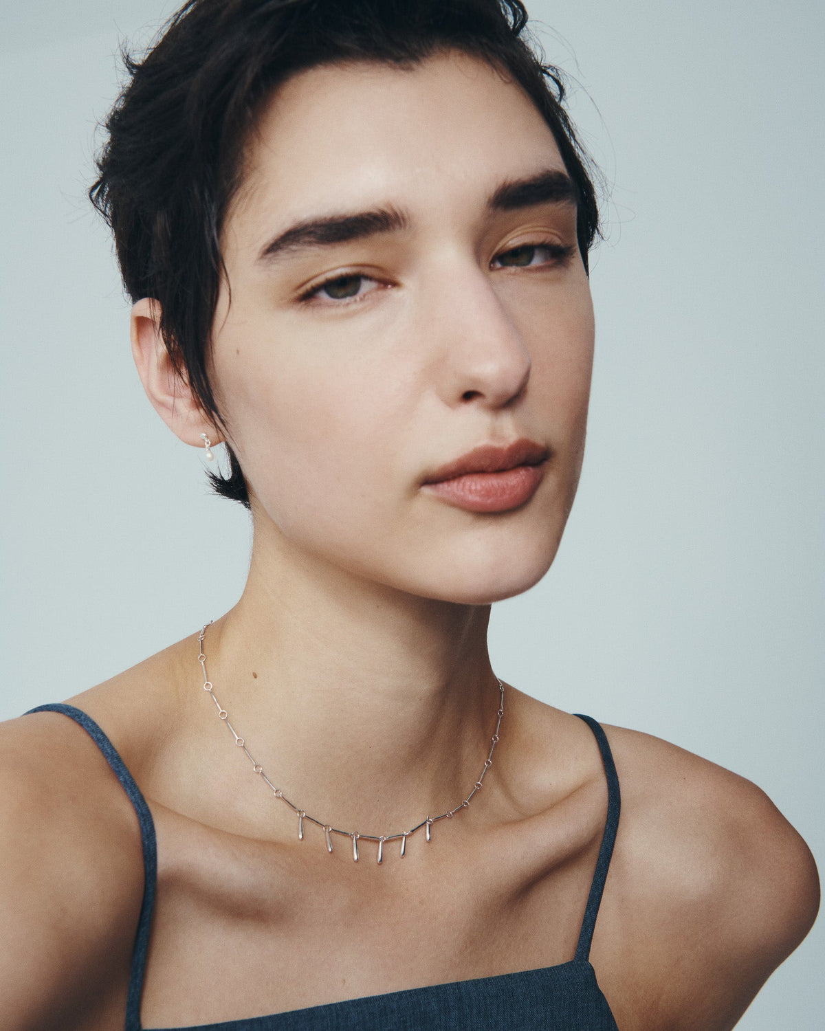 Stilla Necklace and Hydra Earrings in Silver, worn
