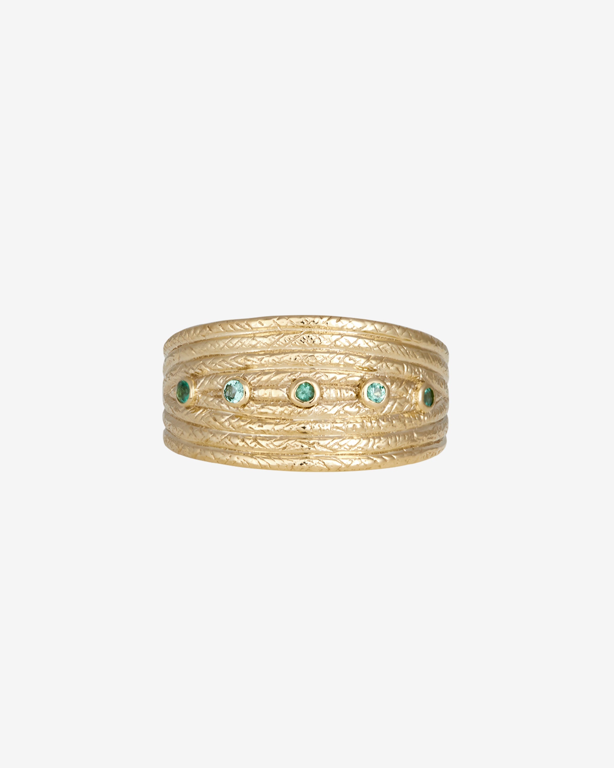 Gold ring with embedded green gemstones on a white background