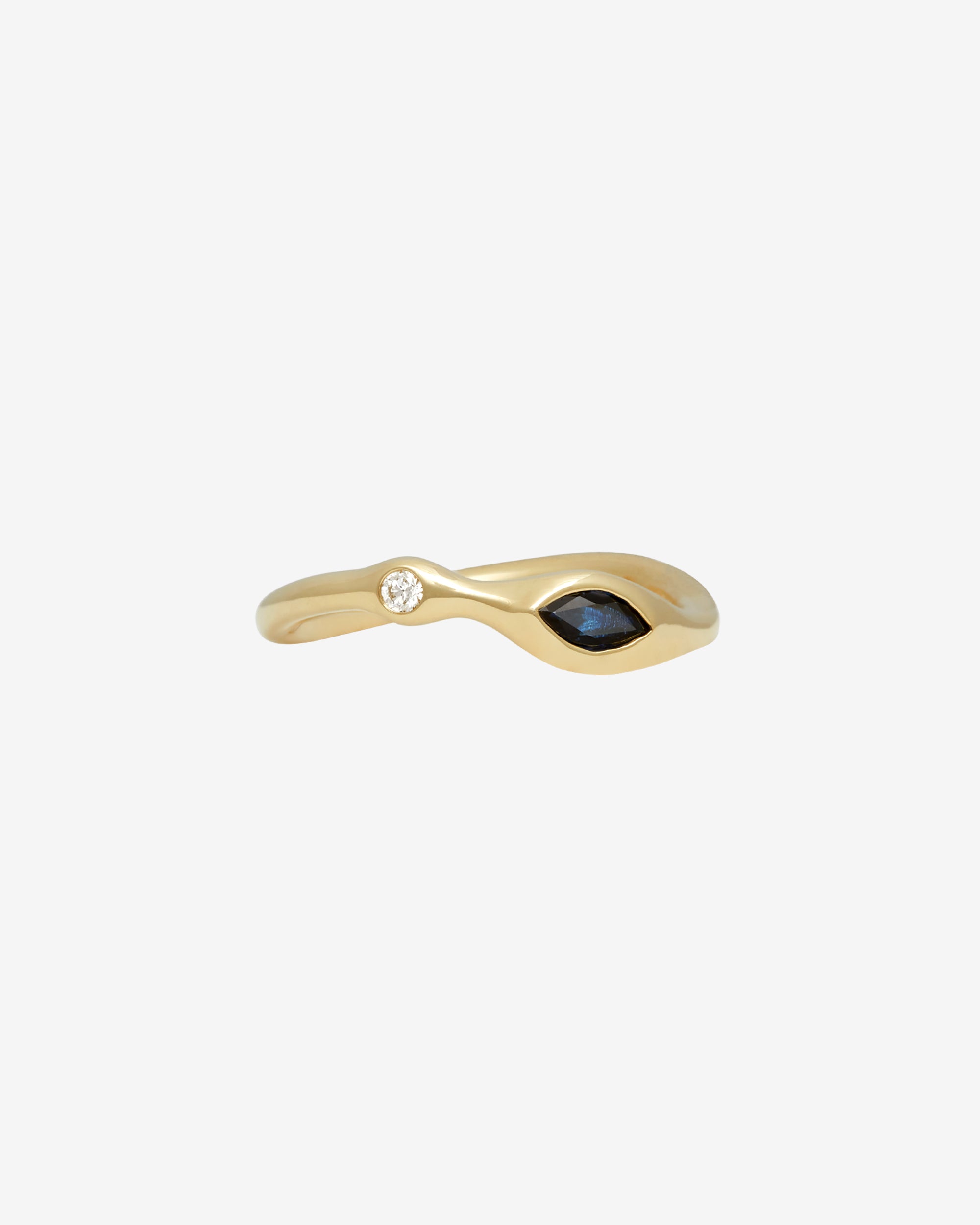 Gold ring with a blue gemstone on a white background