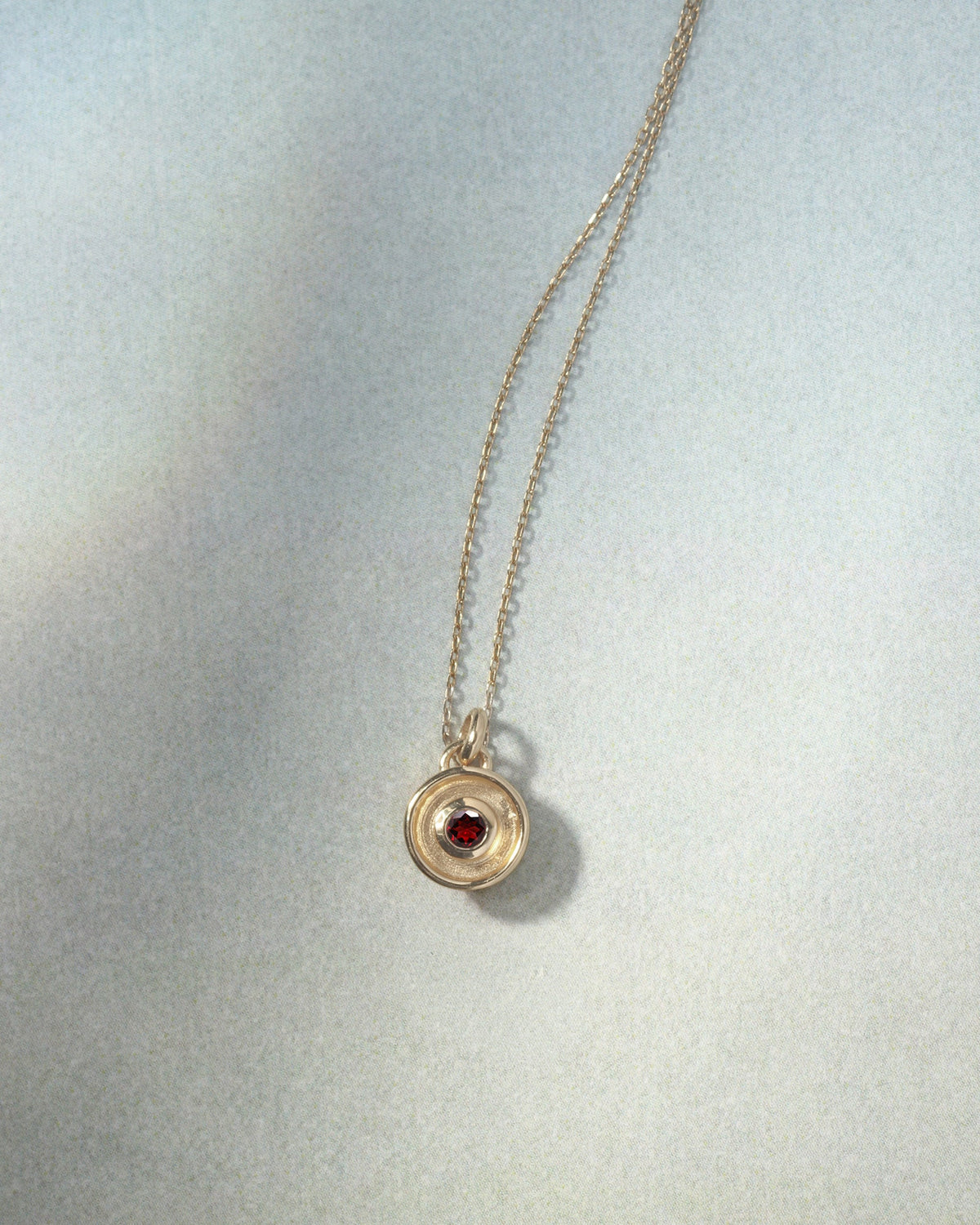 Element Fire Garnet Necklace Solid Gold, flatlay