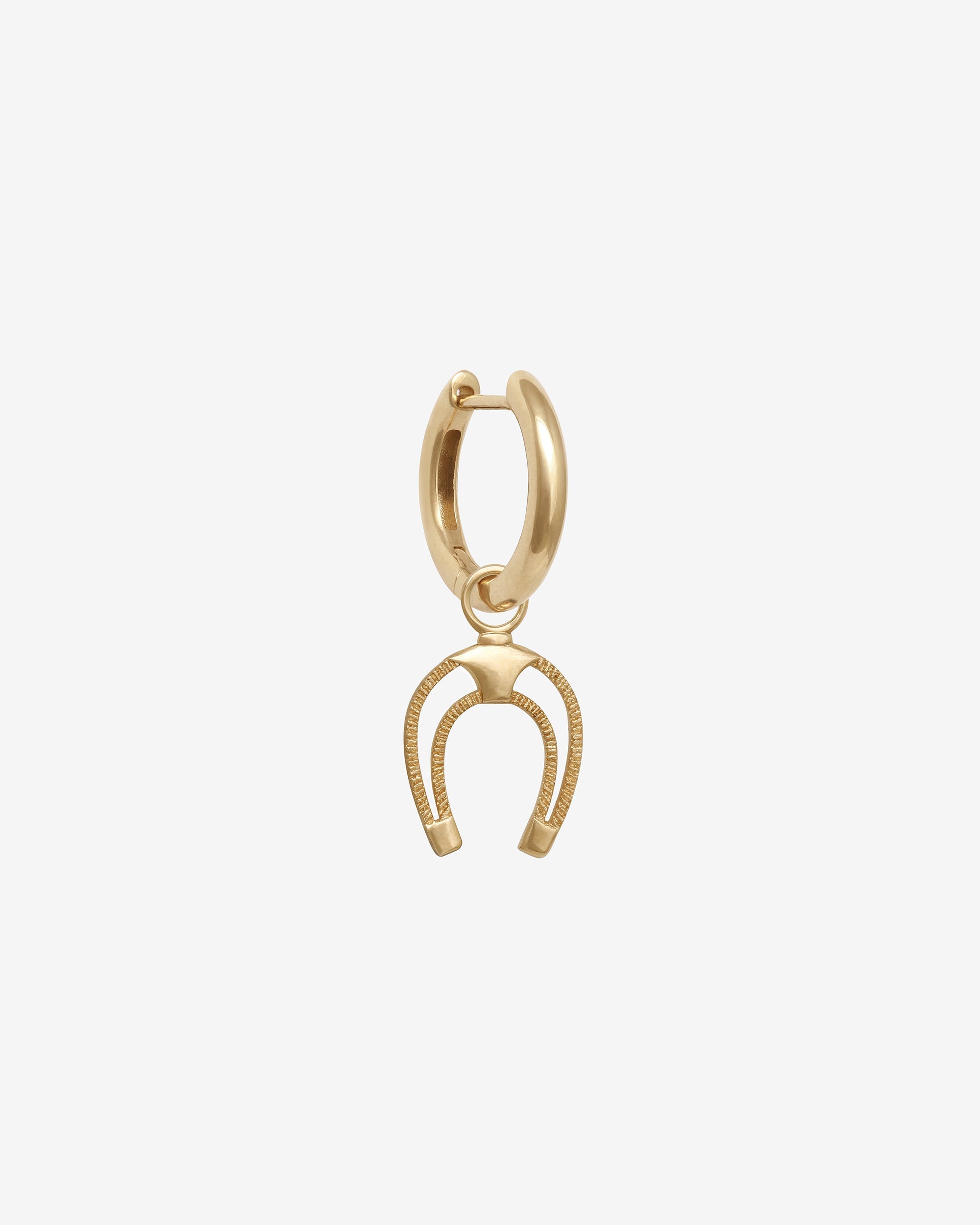 Gold horseshoe charm on a white background