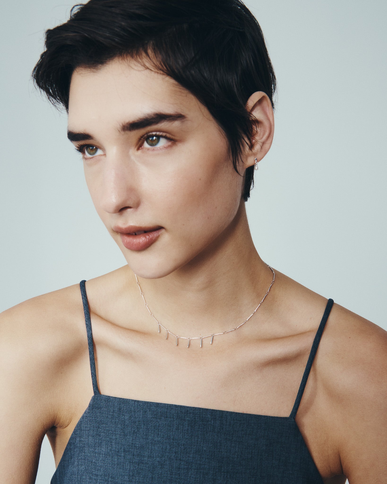 Stilla Necklace and Hydra Earrings in Silver, worn