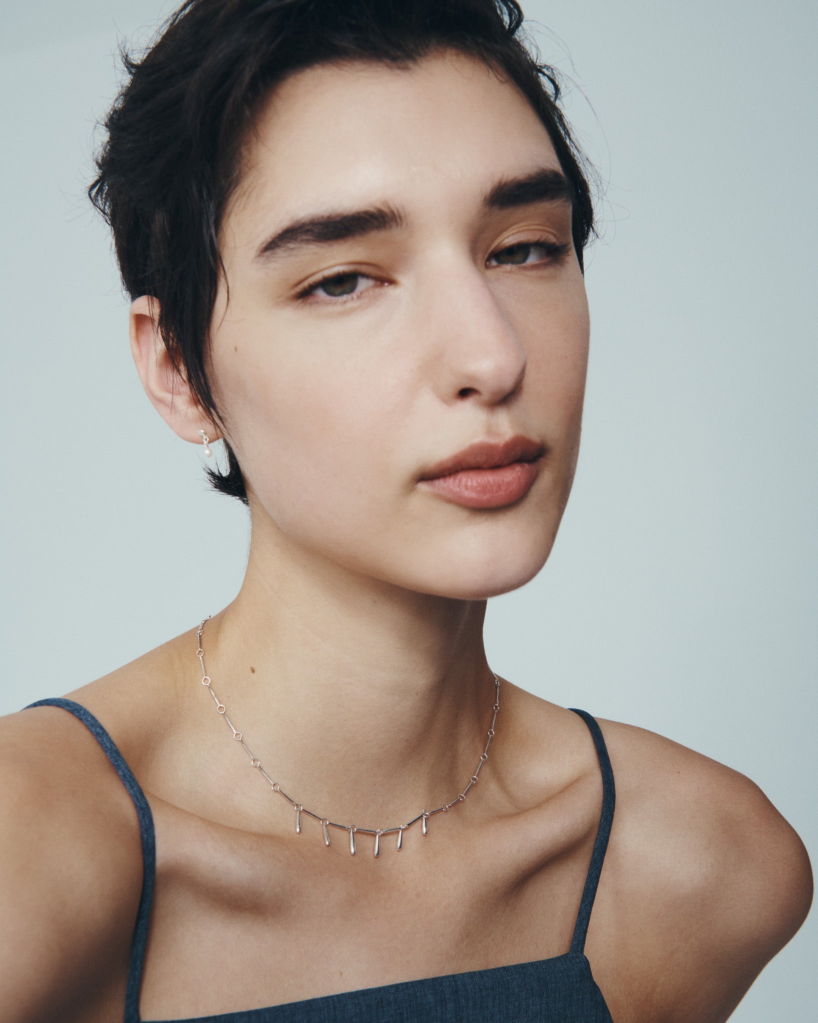 Stilla Necklace and Hydra Earrings in Silver, worn